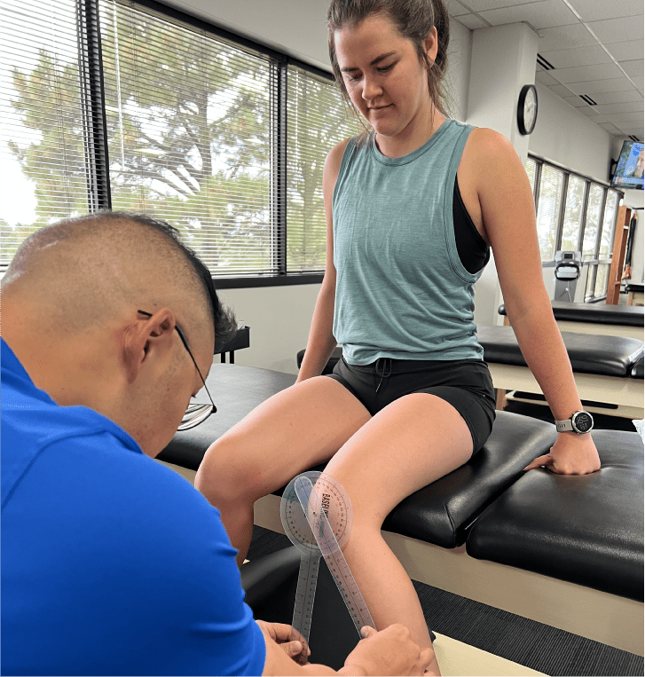 Physical therapist measuring a patient’s knee range of motion during an evaluation at Epic Physical Therapy.